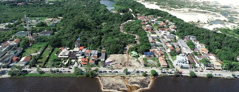 Fotografia aérea de drone mostra a Lagoa da Conceição com águas de tonalidade marrom-avermelhada e com grande banco de areia em frente à Avenida das Rendeiras. Resultado de rompimento de lagoa de tratamento de efluentes.